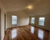 Bonus room featuring light wood-type flooring and lofted ceiling