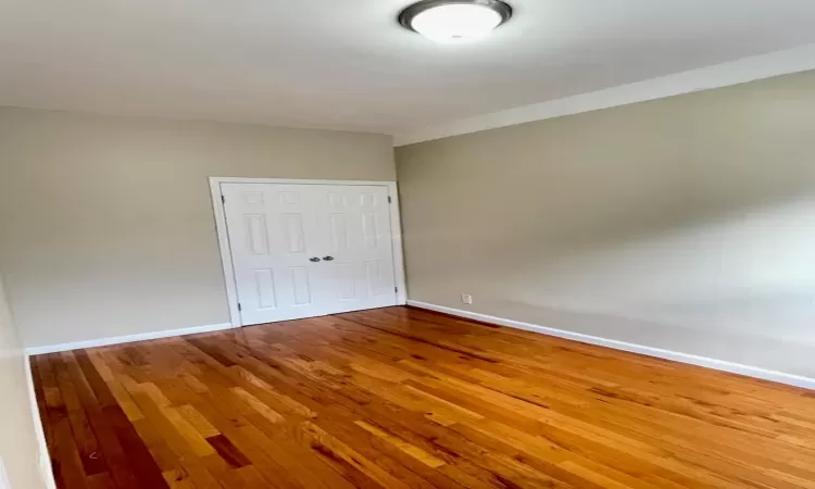 Empty room featuring hardwood / wood-style flooring