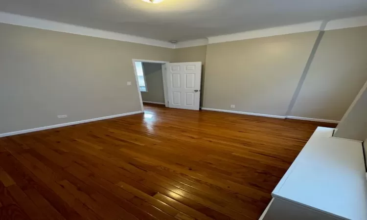 Empty room with dark hardwood / wood-style floors