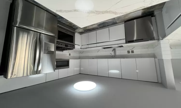 Kitchen with dishwasher, stove, sink, fridge, and white cabinetry