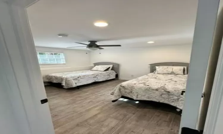 Bedroom featuring laminate style flooring and ceiling fan