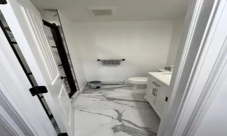 Bathroom with vanity, toilet, and walk in shower