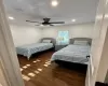 Bedroom with ceiling fan and hardwood flooring.