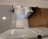 Bedroom featuring baseboard heating, ceiling fan, and dark wood-type flooring