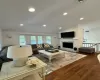 Living room with lofted ceiling and Hardwood flooring