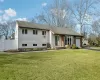 View of front facade featuring a front lawn and a garage