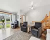 Living room featuring light hardwood / wood-style flooring and lofted ceiling