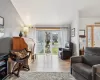 Living room featuring ceiling fan, radiator heating unit, vaulted ceiling, and light wood-type flooring