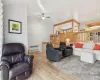 Living area with vaulted ceiling and light wood-type flooring