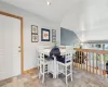 Carpeted living room featuring beam ceiling, a baseboard radiator, plenty of natural light, and a wall mounted AC