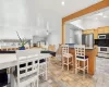 Kitchen featuring decorative backsplash, dark stone counters, stainless steel appliances, a center island, and lofted ceiling