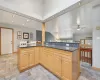 Kitchen with sink, dark stone counters, vaulted ceiling, decorative backsplash, and appliances with stainless steel finishes