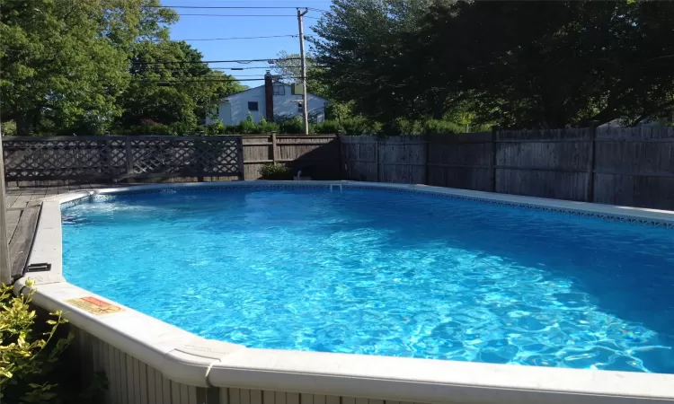 View of swimming pool featuring fence and a fenced in pool