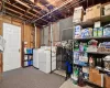 Basement with white fridge and gas water heater