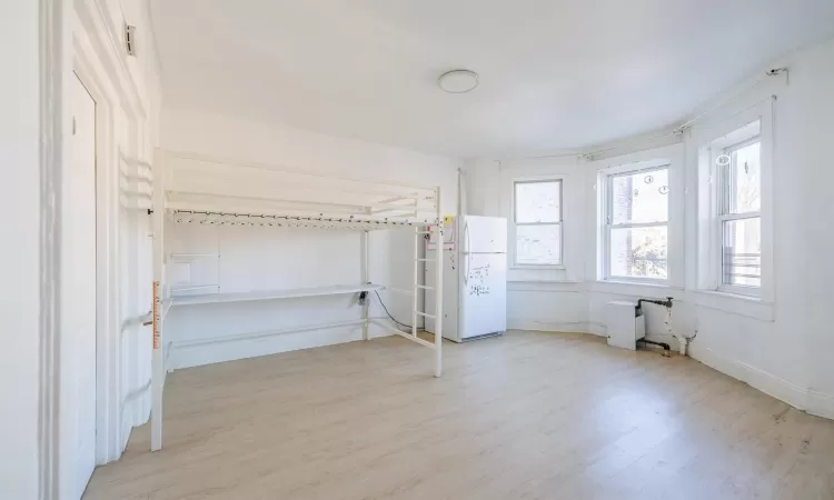 Unfurnished bedroom with light wood-type flooring