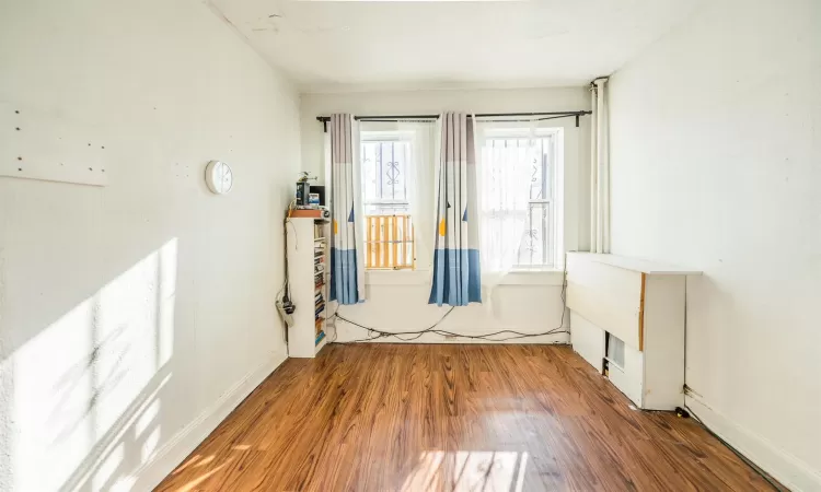 Empty room featuring dark hardwood / wood-style flooring