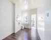 Entrance foyer with radiator heating unit and dark wood-type flooring