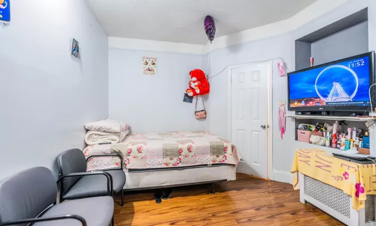 Bedroom with dark wood-type flooring