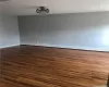 Empty room featuring dark wood-type flooring