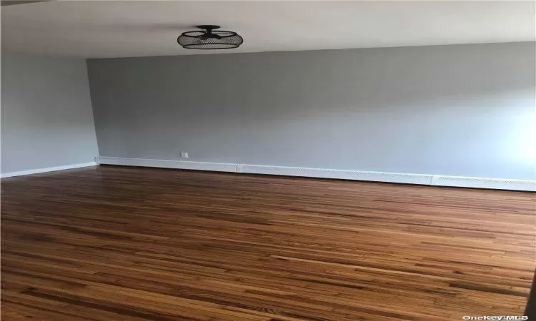 Empty room featuring dark wood-type flooring