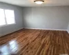 Empty room featuring dark hardwood / wood-style floors and baseboard heating