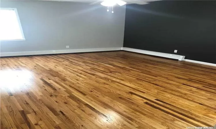 Empty room featuring hardwood / wood-style flooring