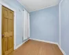 Unfurnished room with wood-type flooring and ornamental molding