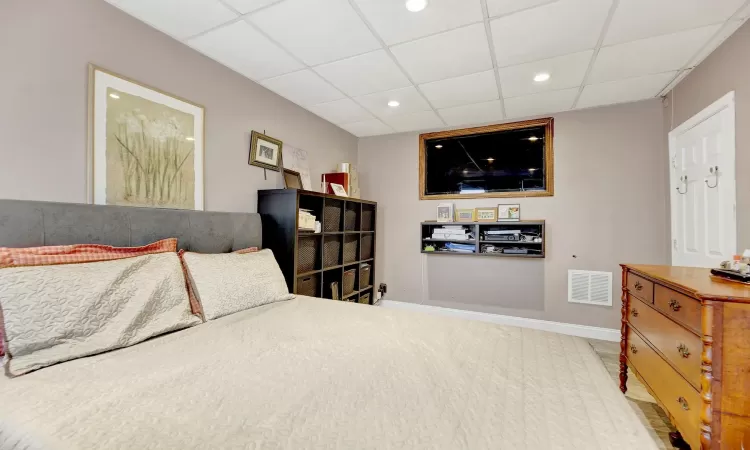 Bedroom with a paneled ceiling