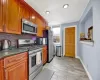 Kitchen with backsplash, stainless steel appliances, and dark stone countertops