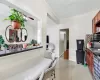 Kitchen featuring sink, ceiling fan, dark stone countertops, light tile patterned flooring, and range