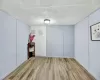 Empty room with a textured ceiling and light hardwood / wood-style flooring