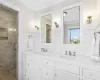 Bathroom featuring vanity, an enclosed shower, ornamental molding, and tile walls