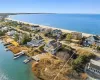 Birds eye view of property featuring a waterfront, dock and beach access