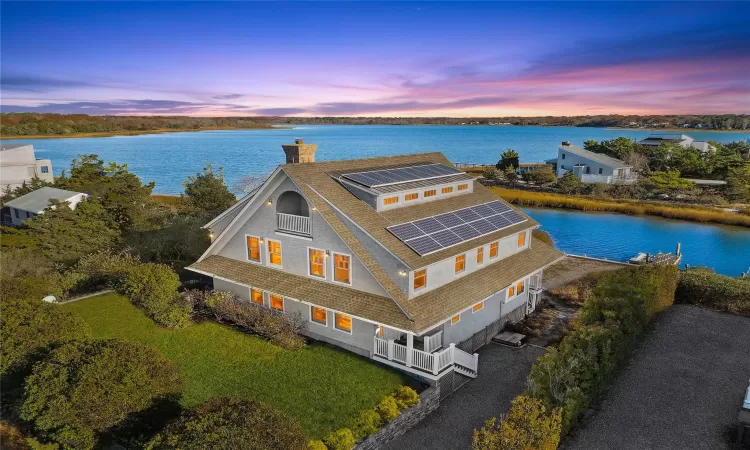 Aerial view at dusk featuring a panoramic water view