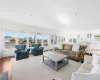 Living room featuring a wealth of natural light, light hardwood / wood-style floors, and ornamental molding