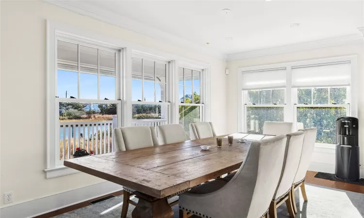 Dining area featuring dark hardwood / wood-style floors and ornamental molding