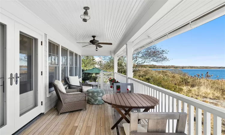 Deck with ceiling fan and a water view