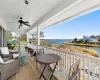 Deck featuring a water view and ceiling fan