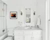 Full bathroom featuring vanity, toilet, ornamental molding, and bath / shower combo with glass door