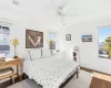 Bedroom featuring dark hardwood / wood-style floors, ceiling fan, and crown molding