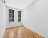 Unfurnished room featuring an AC wall unit and light hardwood / wood-style floors