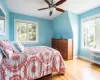 Bedroom featuring ceiling fan, light hardwood / wood-style flooring, and vaulted ceiling