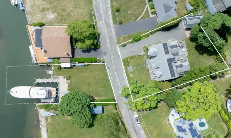 Birds eye view of property with a water view