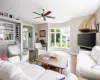 Living room with light hardwood / wood-style floors and ceiling fan