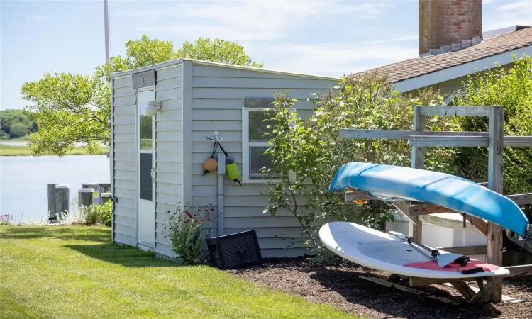 View of outbuilding with a yard