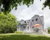 Back of property featuring a yard and a wooden deck