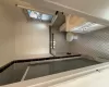 Bathroom featuring tile patterned floors, vanity, tile walls, toilet, and a shower with shower door