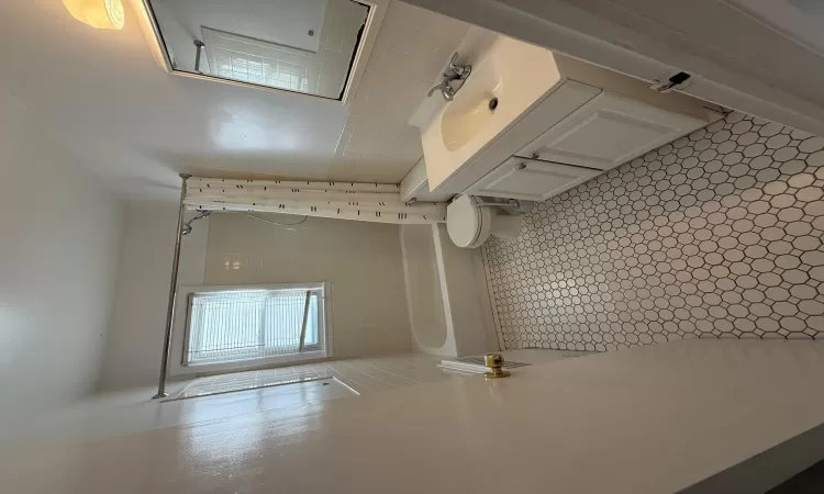 Full bathroom with shower / bathtub combination with curtain, tile patterned floors, toilet, vanity, and tile walls