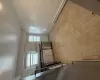 Kitchen featuring a healthy amount of sunlight, white cabinetry, dishwasher, and a baseboard radiator