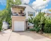 View of front of house with a balcony and a garage